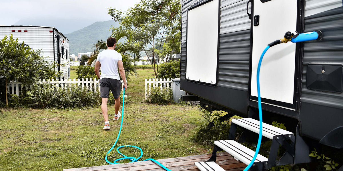 RV connected to a potable-water hose at a campsite