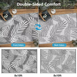 Double-sided outdoor rug with leaf pattern on a wooden deck. 