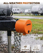 Orange weatherproof tongue lock with chain attachment on a rainy day with RVs 